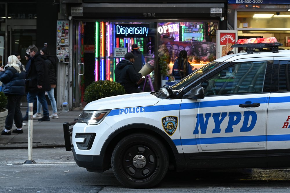 An NYPD patrol vehicle sits outside "Smoker's World" cannabis dispensary store near Times Square on Feb. 8, 2023.