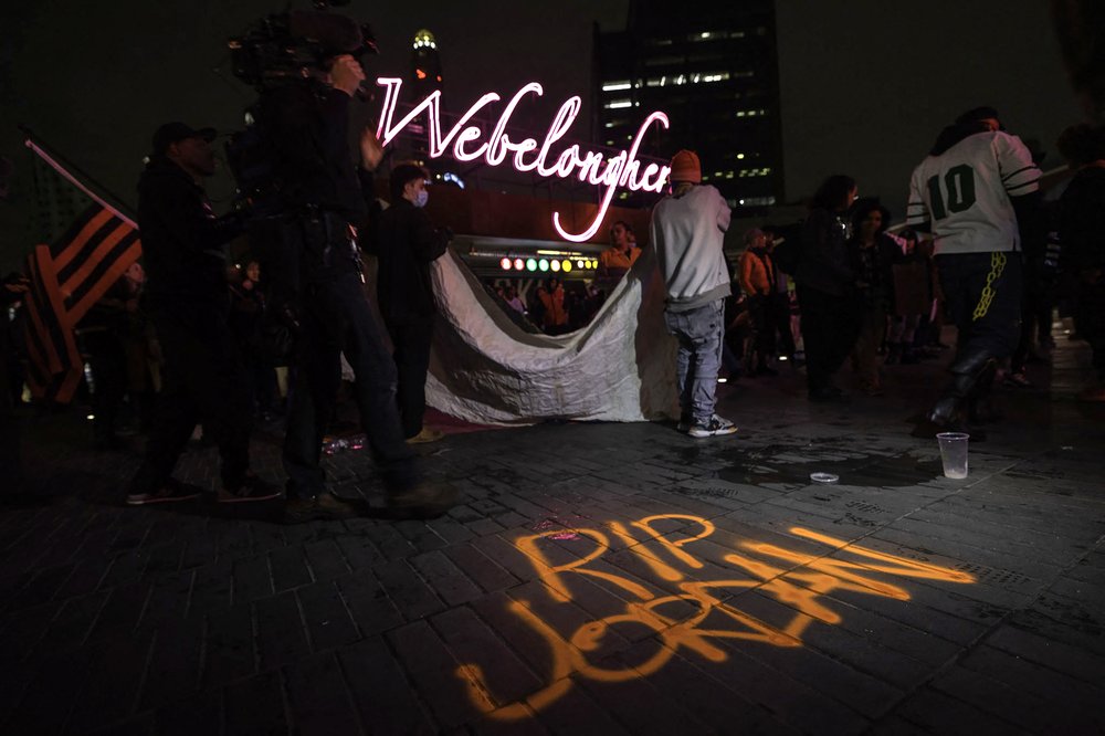 Protestors gather next to a graffiti on the sidewalk reading "RIP Jordan" at Barclays Center Arena in Brooklyn and march to the 7th police precinct to protest the NYPD's response to the killing of Jordan Neely, May 4, 2023.