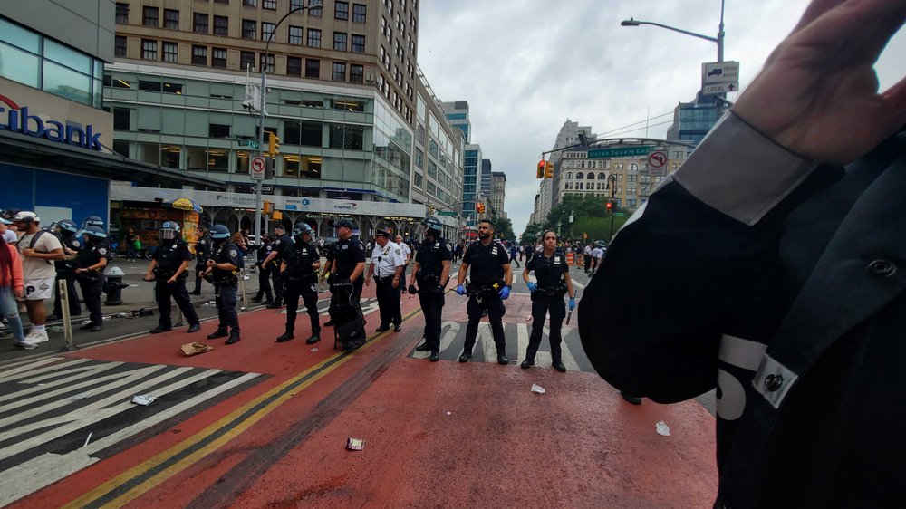 Several policemen stand in a row.