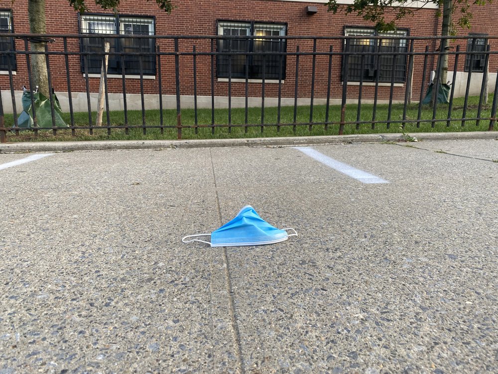 Face mask discarded on sidewalk in front of Forest Hills High School, Queens.
