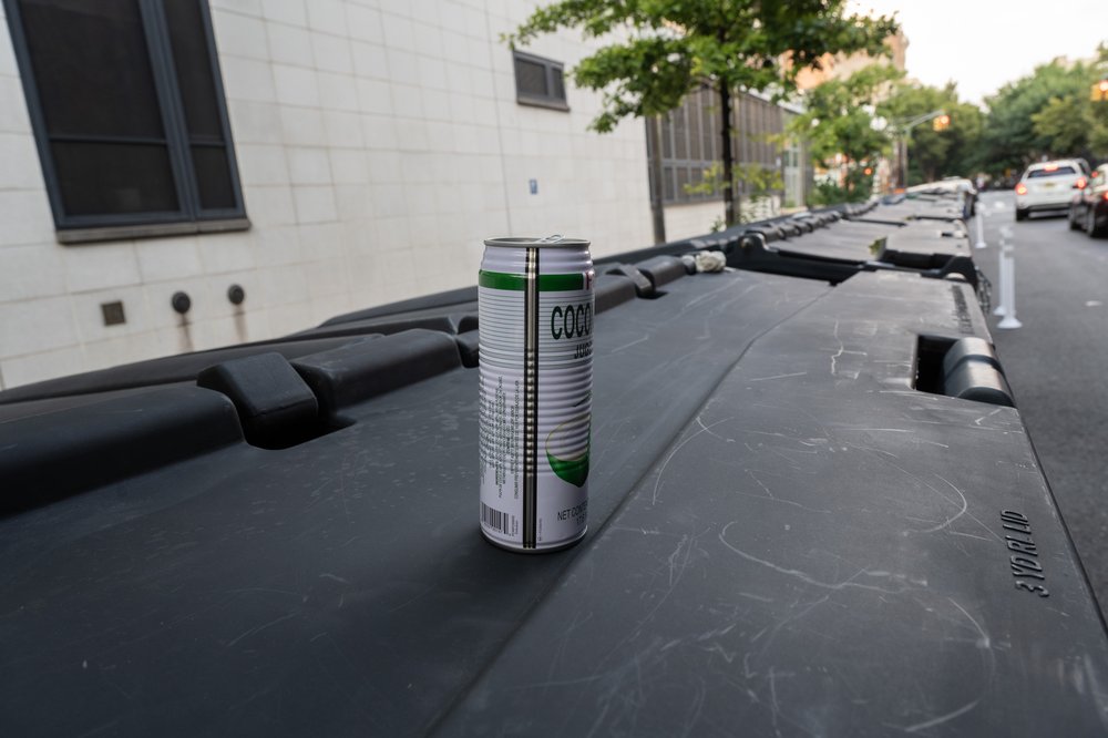 A beverage container sits atop the trash bin, Aug. 16, 2023.