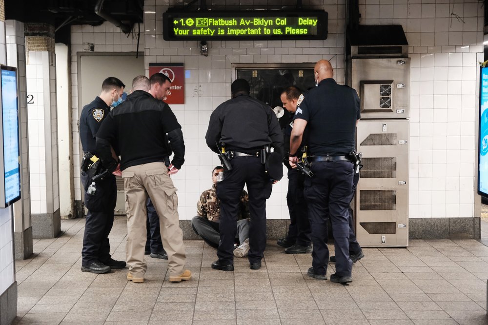 Police talk to a man in a Times Square subway station following a call to police from riders on April 25, 2022 in New York City
