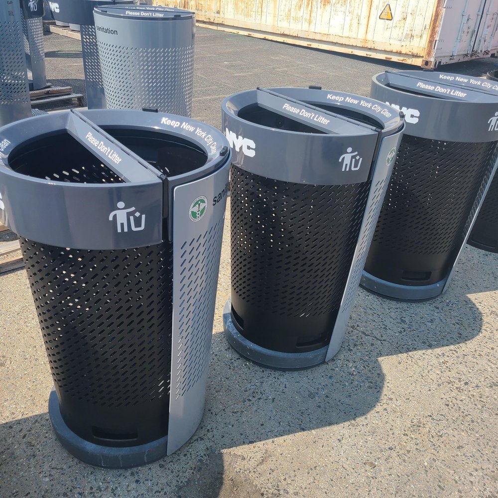 A row of gleaming new New York City trash cans.