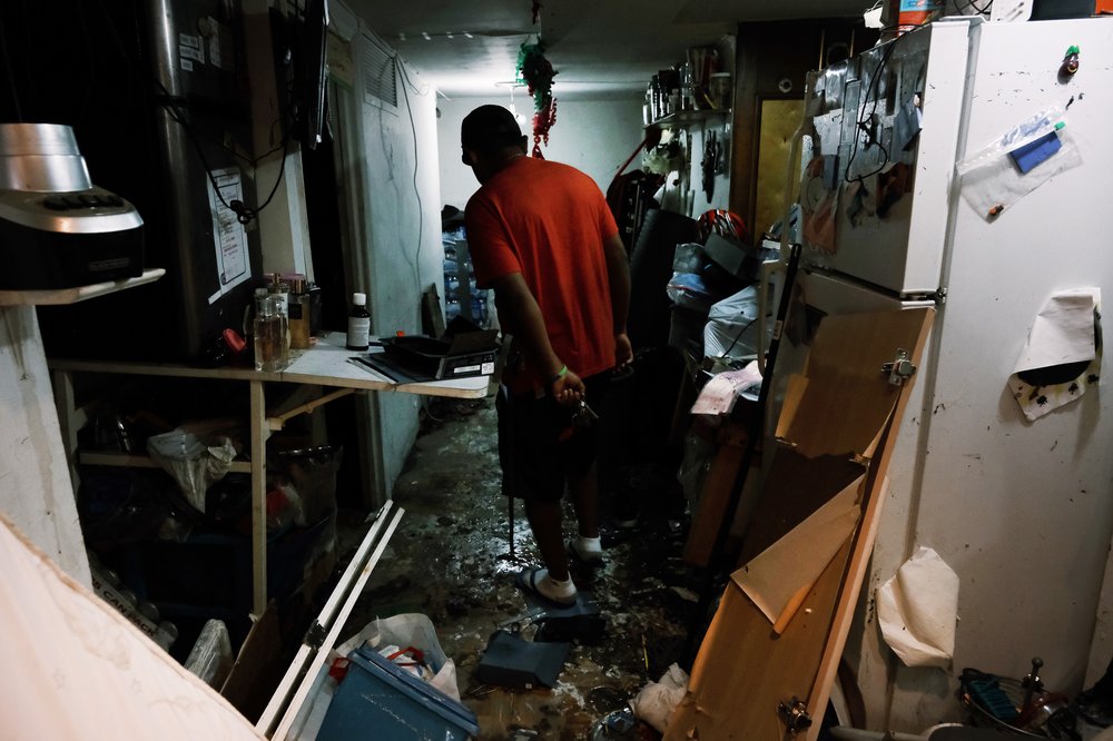 A Queens resident walks through his flooded basement level apartment after the remnants of Hurricane Ida swept through the New York, New Jersey and Connecticut, causing massive flooding and at least 43 deaths across the tristate. Photo taken Sept. 3, 2021.