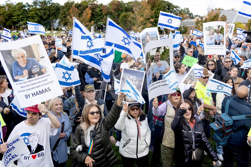 A large crowd waving Israeli flags gathers in a park in Livingston, New Jersey