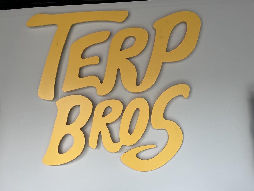 A giant yellow Terp Bros sign adorns a wall inside the dispensary.