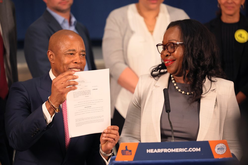 Mayor Eric Adams holds up the lawsuits New York City filed against e-cigarette companies at City Hall on July 10, 2023. Mayor Adams was joined by NYC's Corporation Counsel Hon. Sylvia O. Hinds-Radix (right), NYC Sheriff Anthony Miranda and members of Parents Against Vaping E-cigarettes.