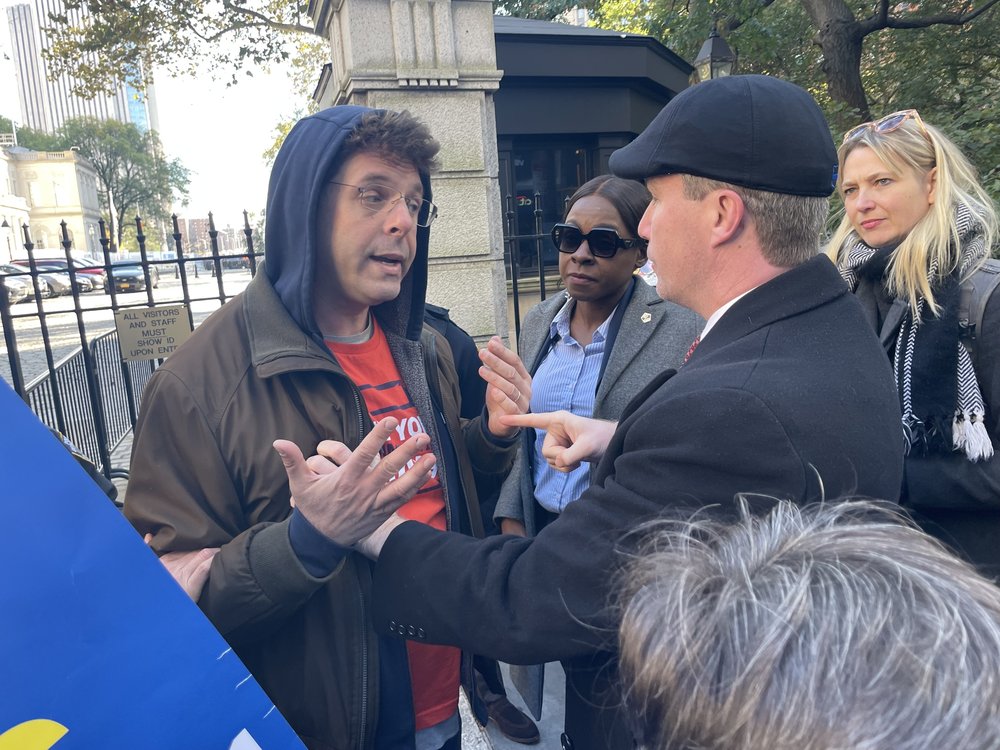 A tense exchange happened between protestor Pete Sikora and an NYPD officer at the west entrance to City Hall. Sikora was among those arrested.