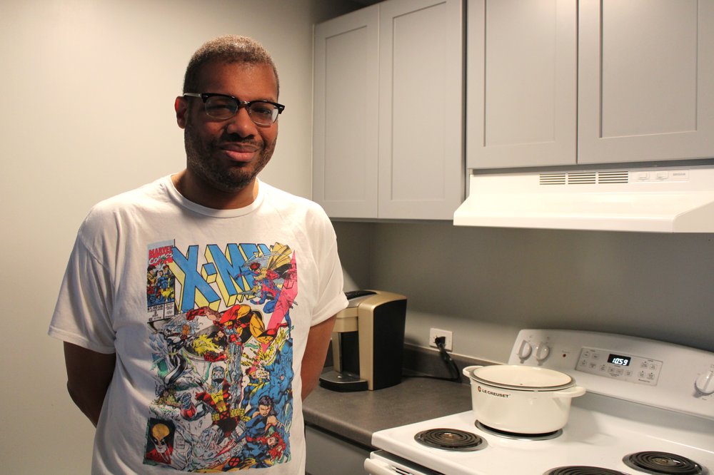 Karim Walker stands in the kitchen of his affordable housing unit.