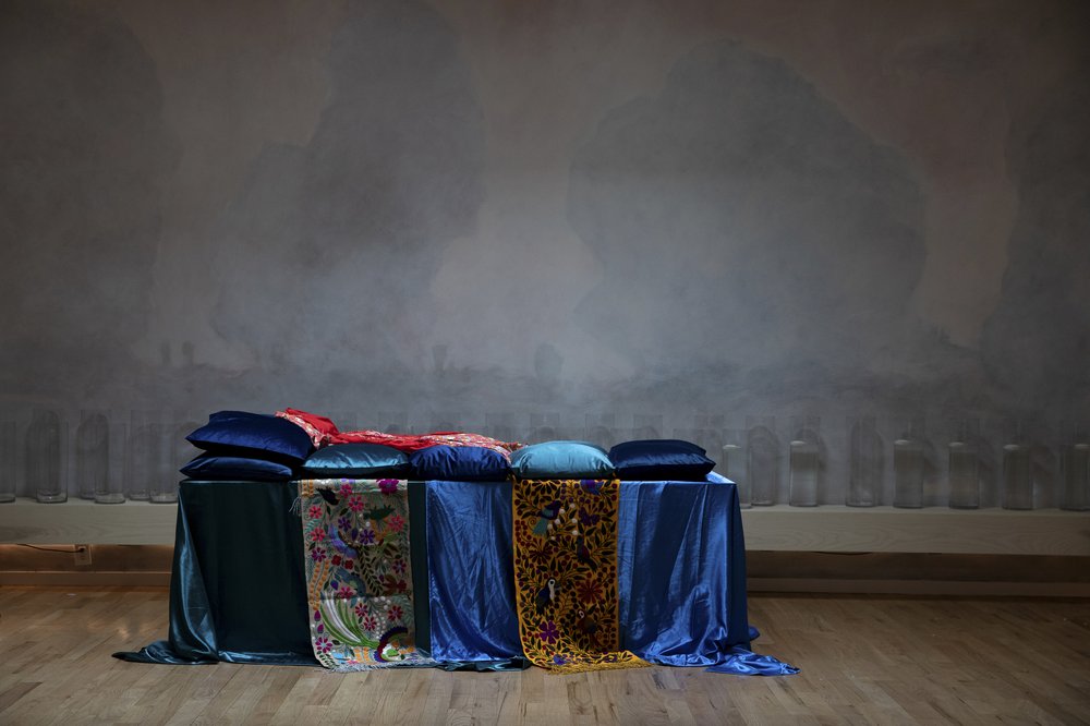 A table draped in multicolored silks.