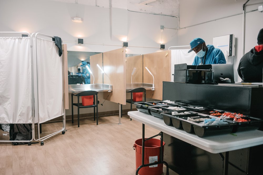 Staff stay nearby while a client uses drugs behind a privacy screen at the OnPoint NYC center in Harlem.