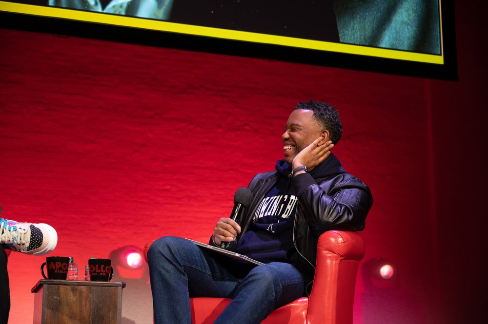 A picture of a man on a stage smiling