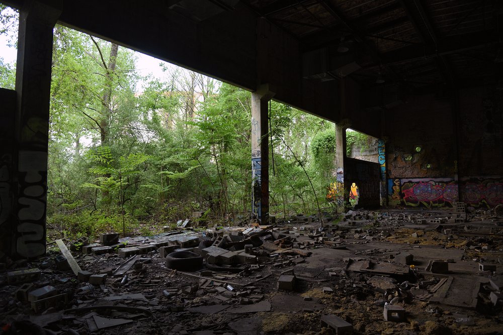 The warehouses, exposed to rain and snow, are slowly collapsing. Cinderblocks and broken concrete litter the woods near the Rossville Municipal Site.