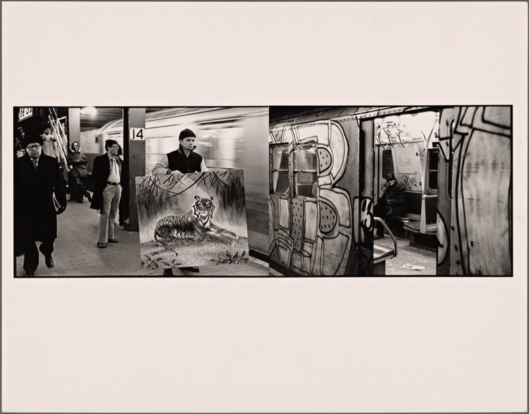 A black and white photo of a man carrying a painting of a tiger into a subway car from the platform. Part of the car appears to be in motion.