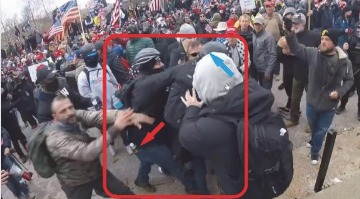 A screenshot from police body camera footage shows Moloney's foamy bee spray hitting officers, prosecutors say.