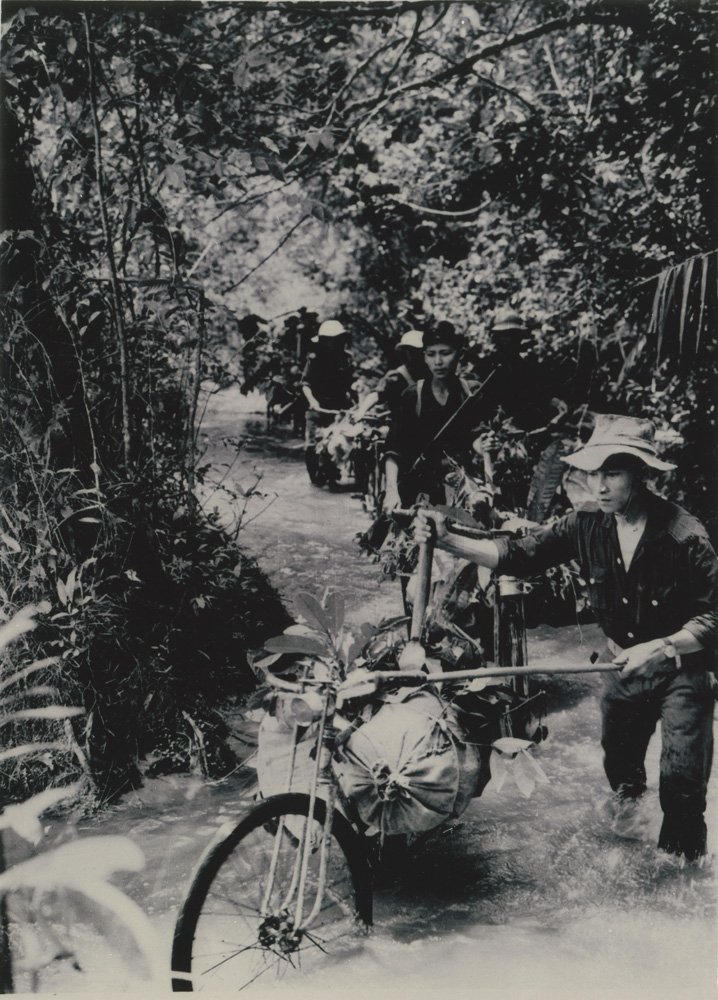 23e5f3cf78-bikes-on-the-ho-chi-minh-trail-1966-jpg.jpeg Bicyclists carry food and ammunition down the Ho Chi Minh Trail, 1966. Dinh Thuy / © Vietnam News Agency<br/>