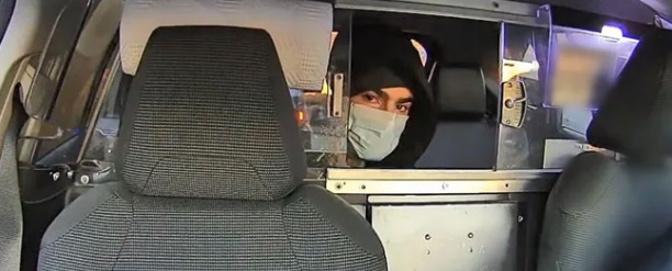 Prosecutors say this photo shows Mangione in the back seat of a taxi included in the indictment.