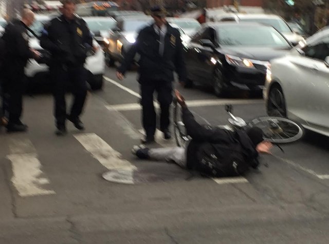 2719cyclist2.jpg An NYPD officer shoves a bicyclist off his bike to give him a ticket, according to a witness.