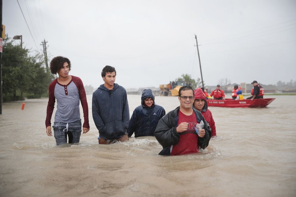 272a9b16bgettyimages-840345016-jpg.jpeg People make their way out of a flooded neighborhood after it was inundated with rain water, remnants of Hurricane Harvey, on August 28, 2017 in Houston, Texas<br>