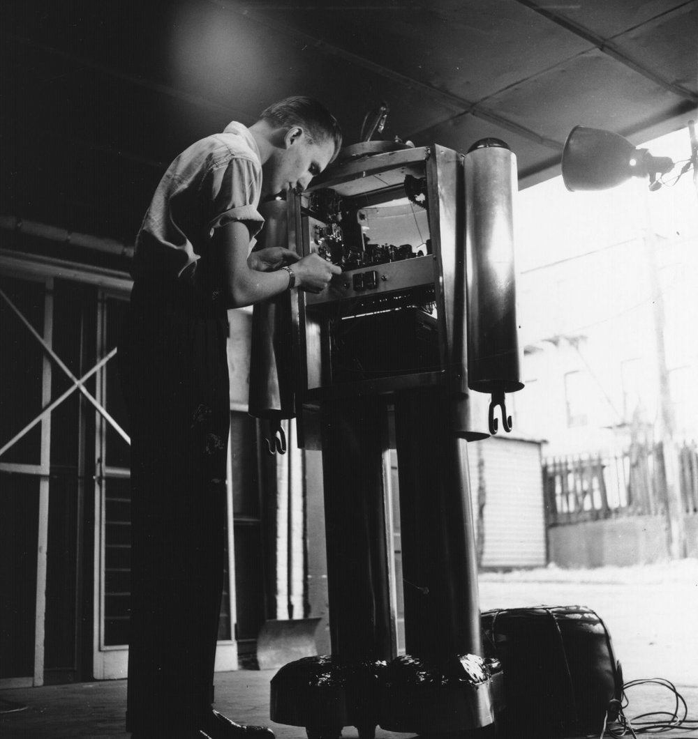 29b721572.jpeg Ronald Hazel of Brooklyn, New York, works on Thodar, his robot. 1960.