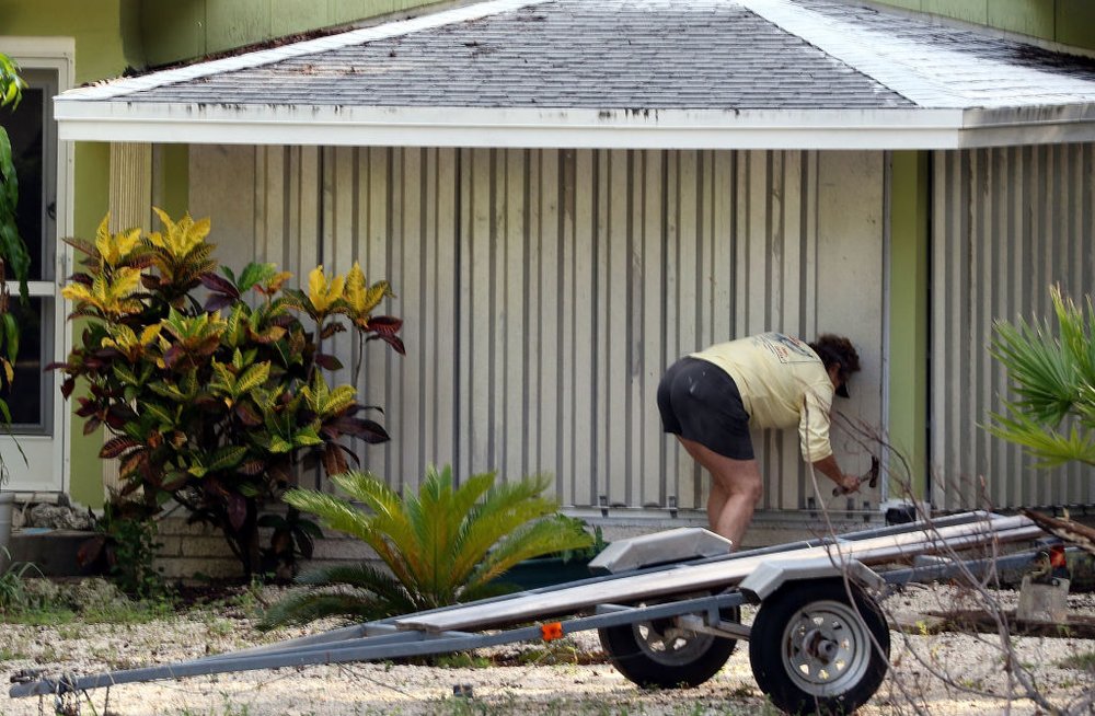 34e0af42dgettyimages-843085118-jpg.jpeg A woman installs hurricane shutters on her home in the Florida Keys on Septeber 5, 2017 in Islamorada, Florida. Residents are evacuating ahead of Hurricane Irma, a powerful storm expected to make landfall this weekend. (Getty Images)