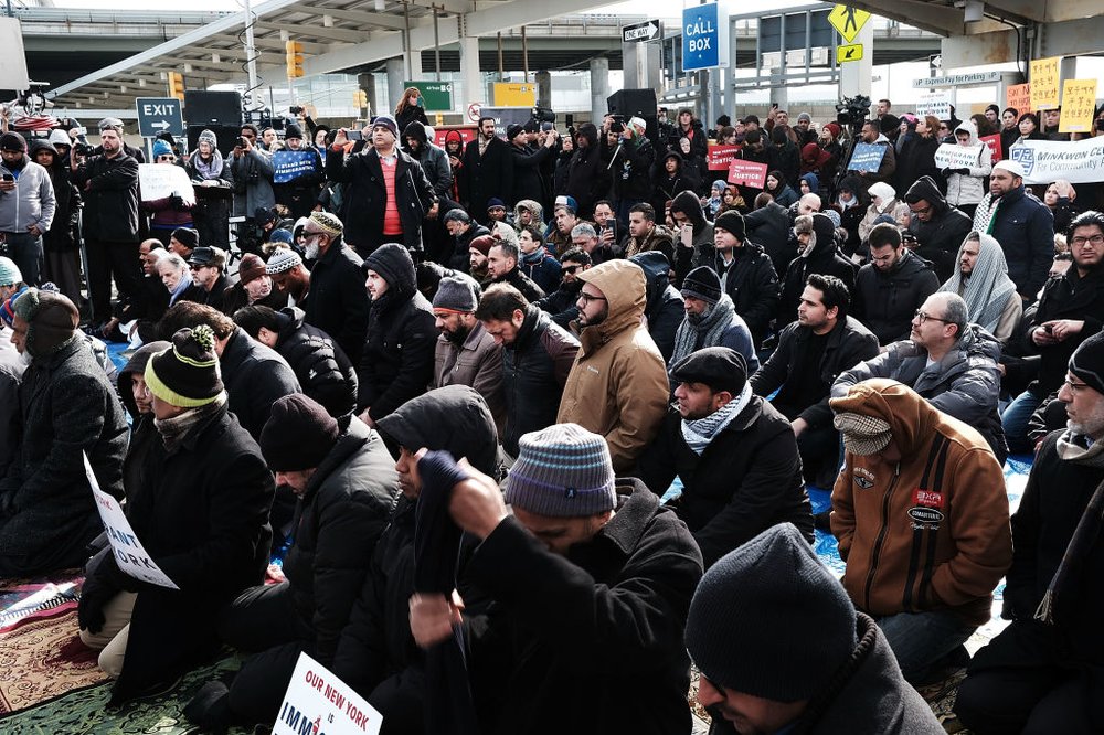 379b3b17egettyimages-633701144-jpg.jpeg Muslim men pray at a prayer and demonstration at JFK airport to protest President Donald Trump's immigration ban, February 3, 2017 <br>
