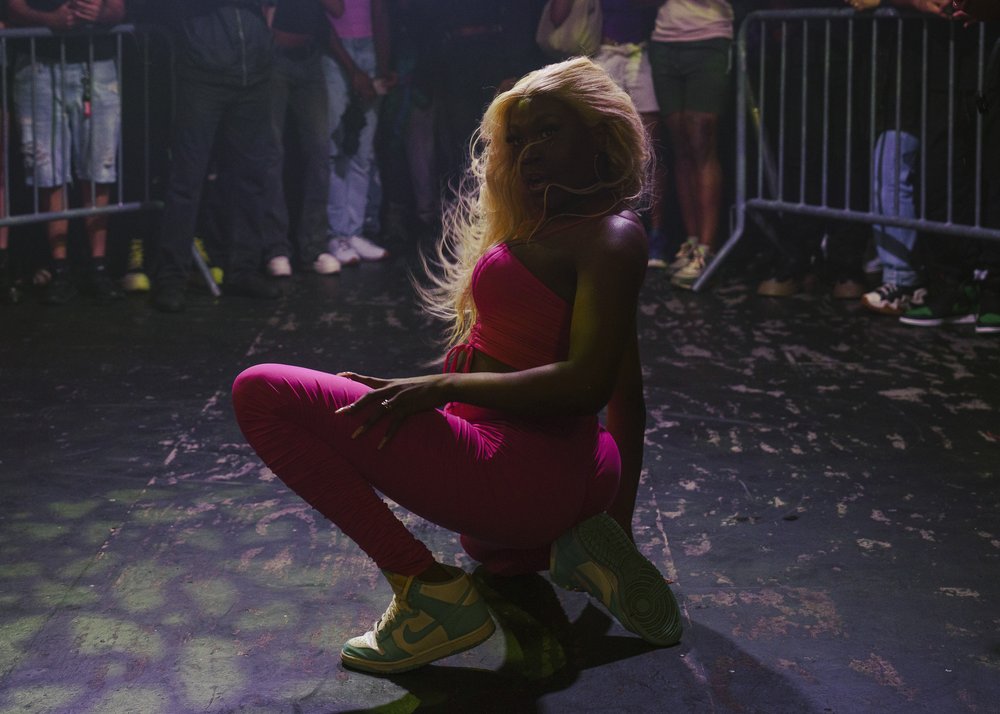 A person squats in dance move.