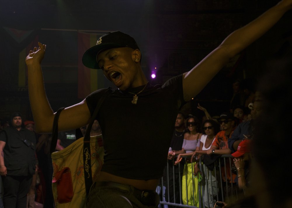 A person yells in excitement in the middle of a dance floor.