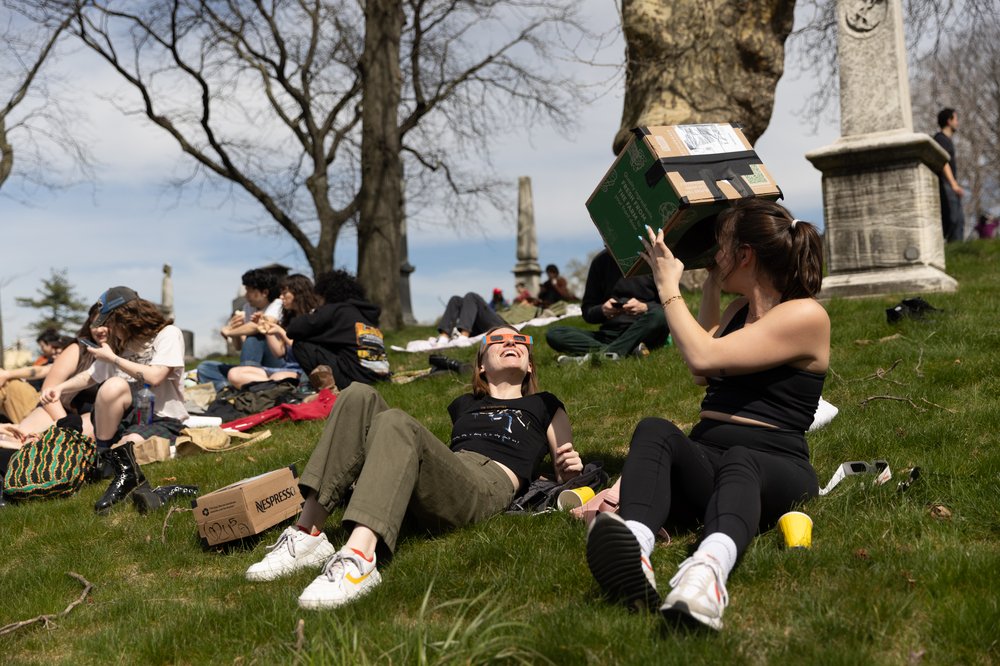 3M3A8761.jpg Sarah Boess and Zoe Whelan watch the solar eclipse at Greenwood Cemetery in Brooklyn, New York on April 8, 2023.