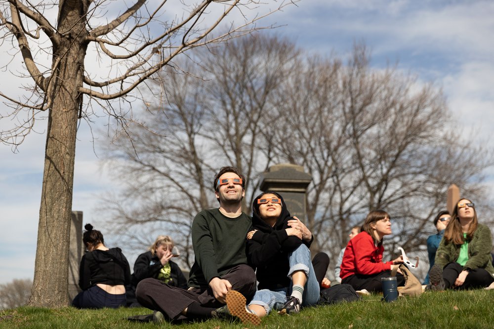 3M3A8800.jpg Sam Bodanis and Faye Saulsbury watch the solar eclipse at Greenwood Cemetery in Brooklyn, New York on April 8, 2023.