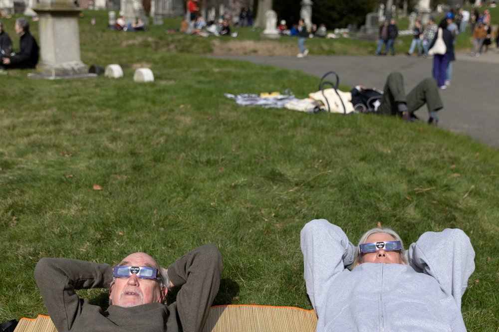 3M3A8850.jpg Richard Leslie and Amy Young watch the solar eclipse at Greenwood Cemetery in Brooklyn, New York on April 8, 2023.