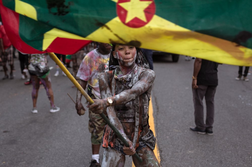 3b546e948090318jouvert-12-jpg.jpeg A reveler waves a Grenadian flag at the 2018 J’Ouvert celebration.