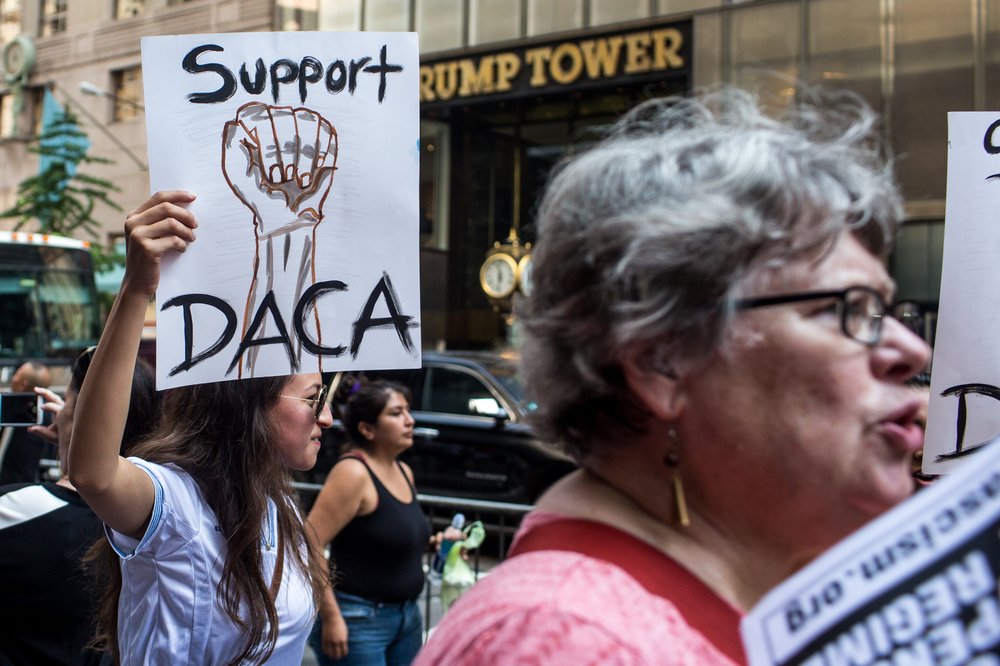 3dcb27195090517dacatrumptower-4-jpg.jpeg A protester at an anti-Trump demonstration holds a sign with a fist painted on it reading "Support DACA" outside Trump Tower in Manhattan.