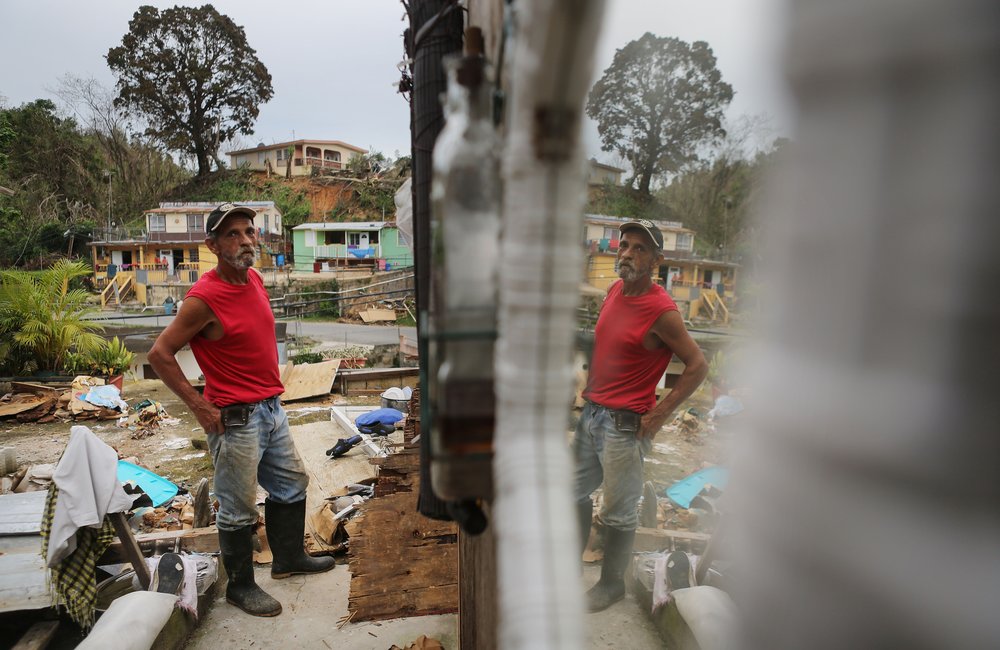 Francisco Zamoro, 69, poses in his former living room, reflected in a mirror still hanging on the wall, three weeks after Hurricane Maria hit the island, on October 12, 2017 in Jayuya, Puerto Rico. <br/>