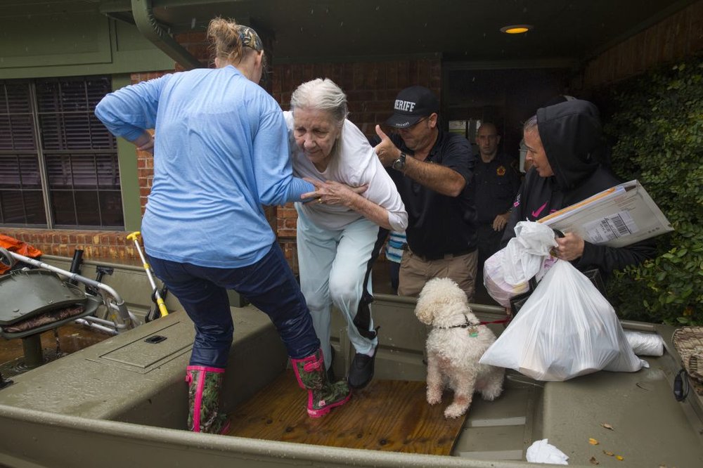 4571b5aecgettyimages-840630102-jpg.jpeg An elderly woman leaves her home and is helped into a boat after flooding caused by heavy rain during Hurricane Harvey August 29, 2017 in the Bear Creek neighborhood in west Houston, Texas<br>(Getty Images)