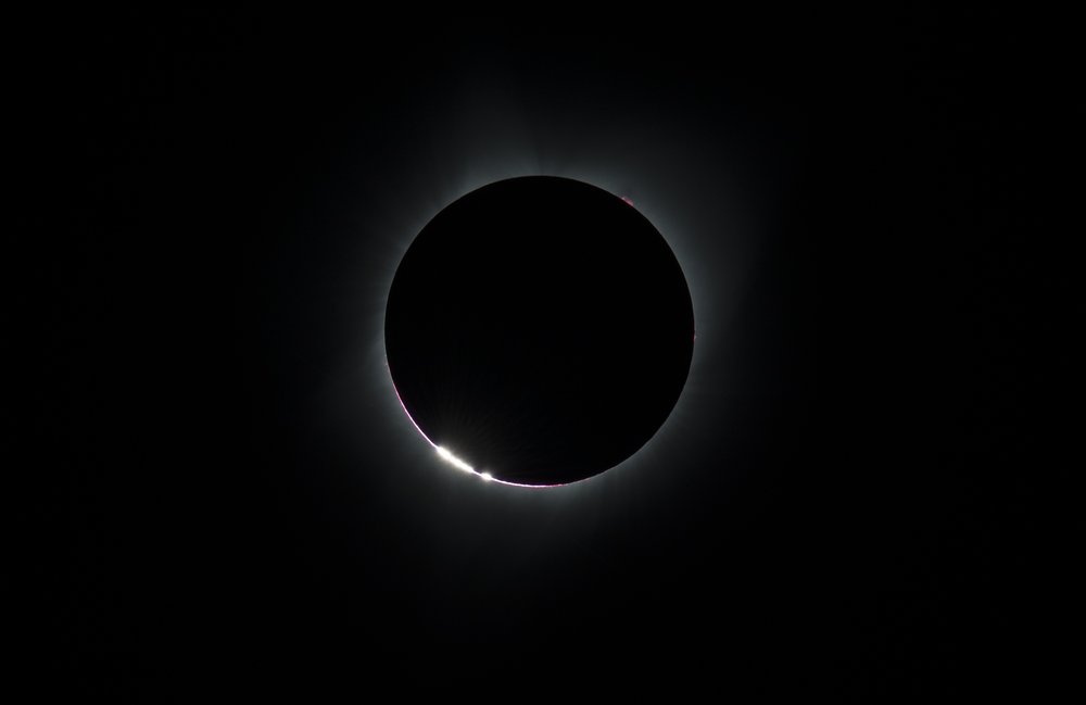 4658e9be7082217moon4-jpg.jpeg The Sun’s corona, only visible during the total eclipse, is shown as a crown of white flares from the surface during a total solar eclipse on Monday, August 21, 2017 from onboard a NASA Gulfstream III aircraft flying 25,000 feet above the Oregon coast. The red spots are called Bailey's beads.