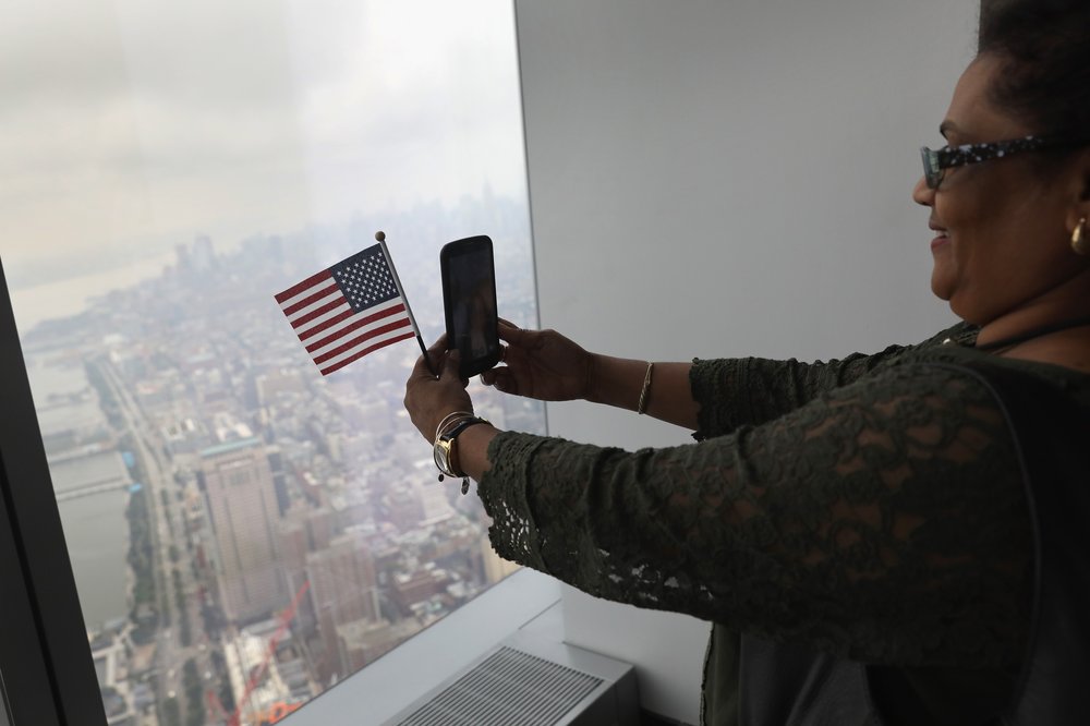 48d8f1d0dgettyimages-831859488-jpg.jpeg An immigrant takes a selfie after becoming a U.S. citizen at a naturalization ceremony held atop the One World Trade Center<br>