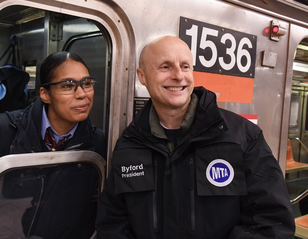 Andy Byford smiles with a subway operator.