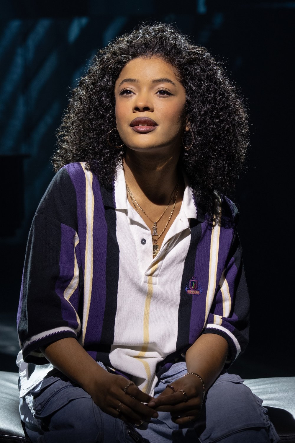 A profile of a woman onstage.