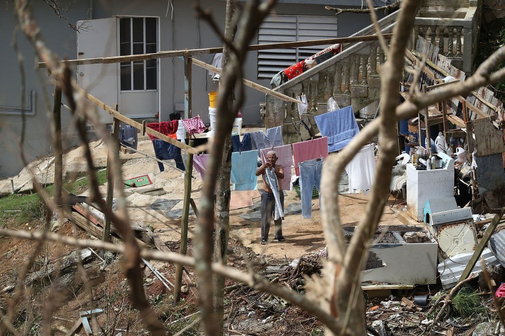 4b1e15fb8092517gettypuertorico17-jpg.jpeg A man hangs laundry up as people wait for the electrical grid to be repaired on Sunday, September 24th in Progreso Barrio Pulguillas, Puerto Rico. (Joe Raedle/Getty Images)