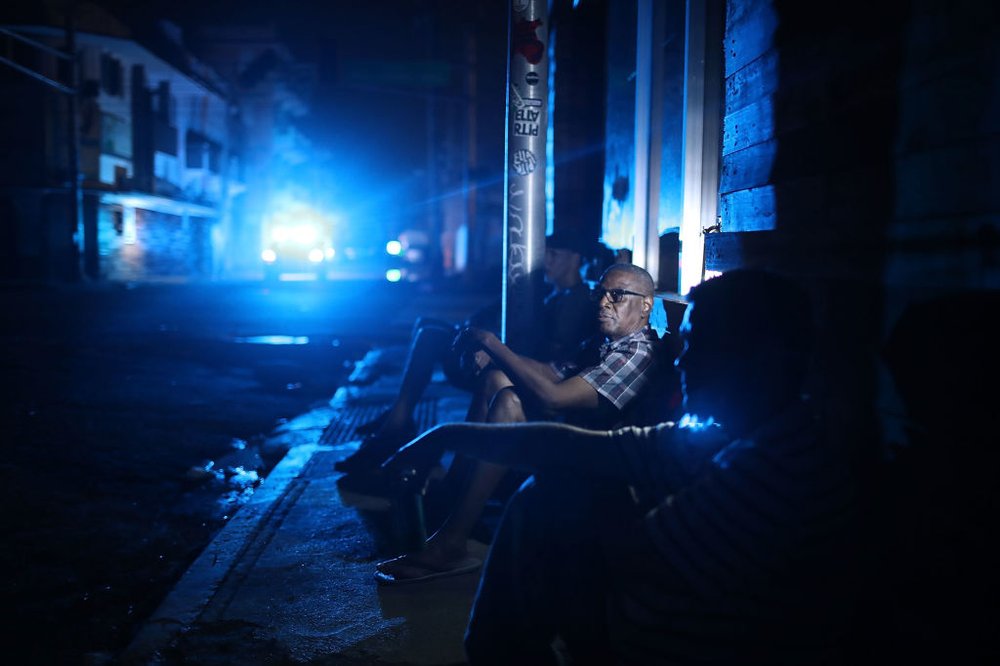 4d9a93ca9092517gettypuertrorico10-jpg.jpeg Jaime Degraff sits outside as he tries to stay cool as people wait for the damaged electrical grid to be fixed after Hurricane Maria on Saturday, September 23rd in San Juan, Puerto Rico. (Joe Raedle/Getty Images)
