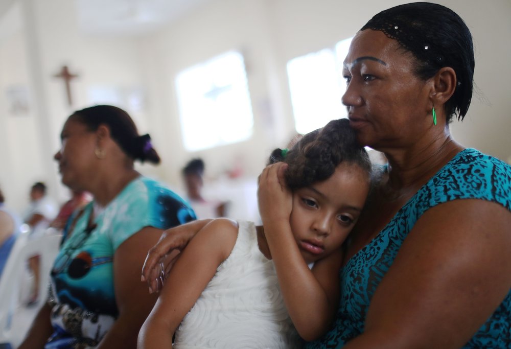 Worshippers gather during Sunday mass in a church without electricity on October 15, 2017 in San Isidro, Puerto Rico.<br/>