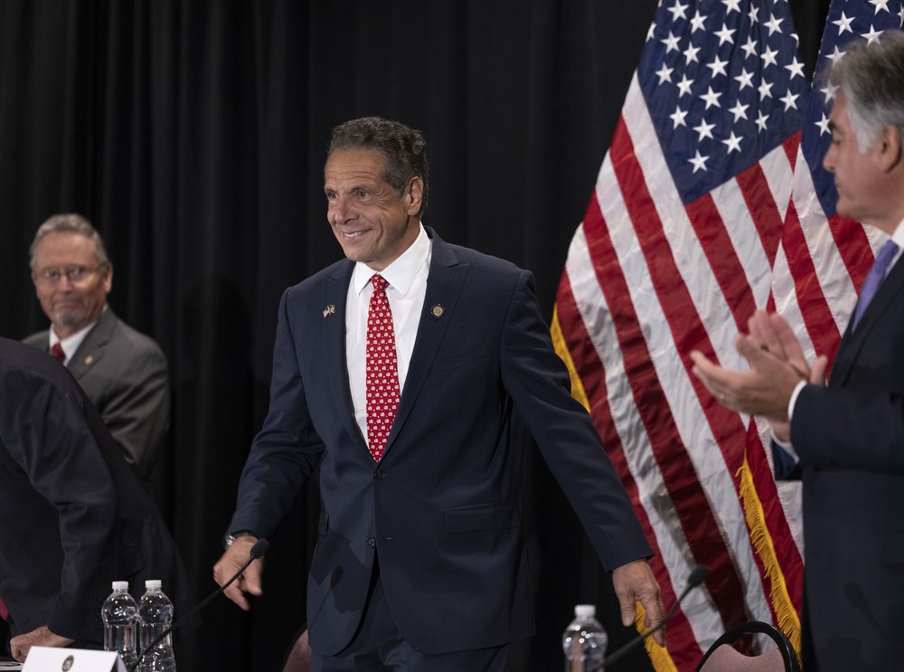 Former Gov. Andrew Cuomo in front of an American flag