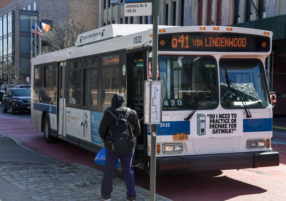 A passenger boards a New York City bus in Queens.