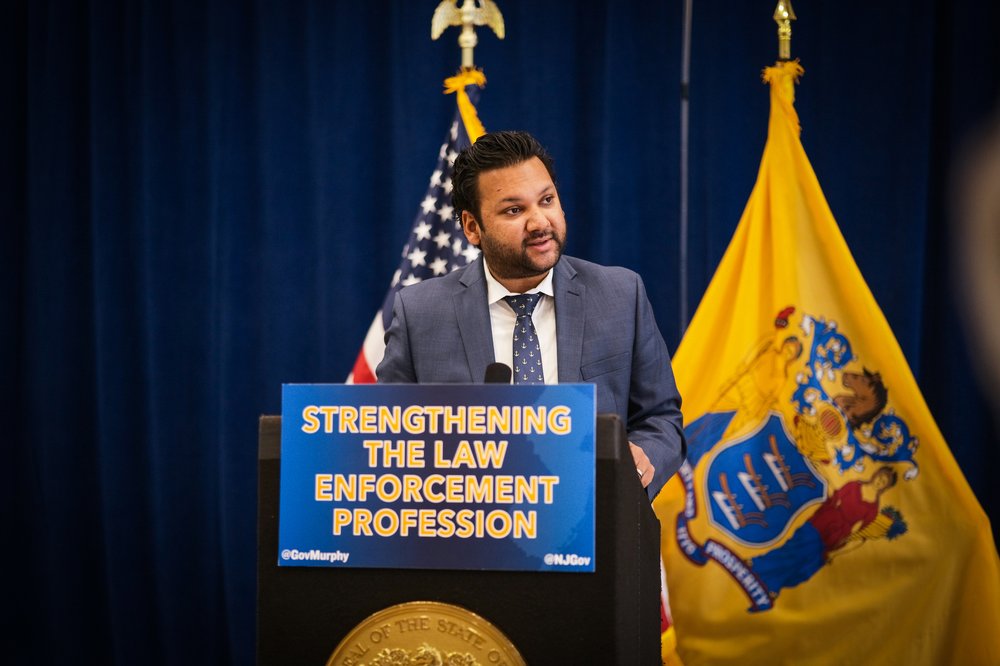 Amol Sinha, executive director of the ACLU of New Jersey, applauds a bill requiring licensure for police.