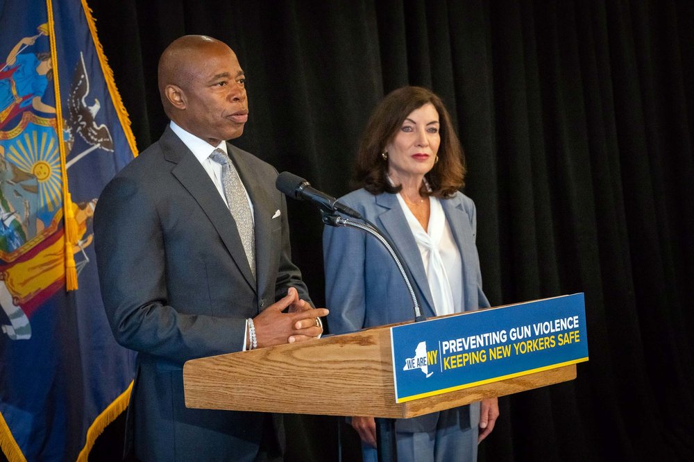 eric adams and kathy hochul at a podium