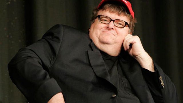 We don't feel the vitriol toward Michael Moore that many do, but one thing's clear: keep him away from an acoustic guitar and flute: