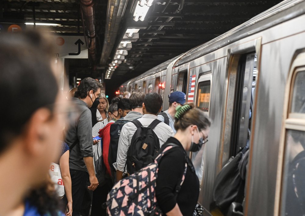 People board a subway.