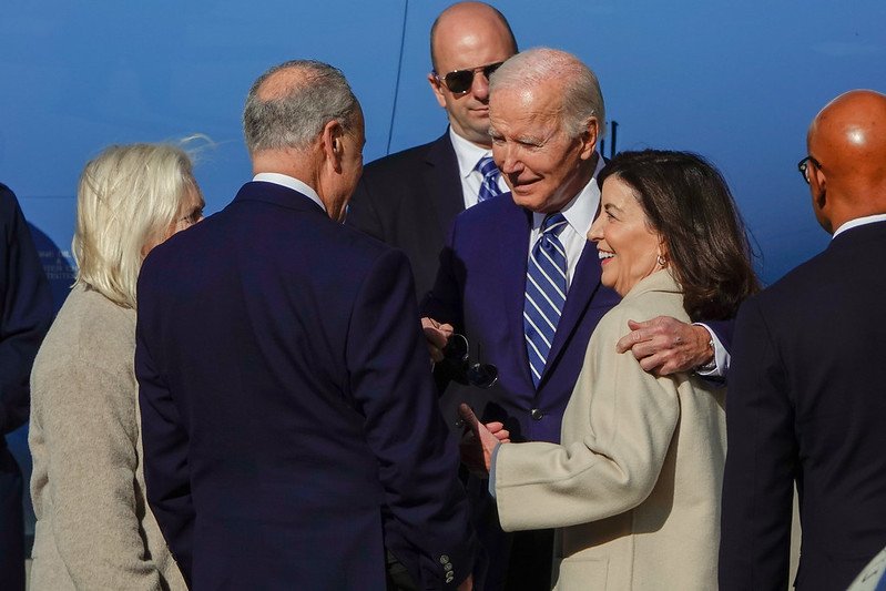 President Joe Biden, with his arm around Gov. Kathy Hochul, speaks to New York's Senators Chuck Schumer and Kirsten Gillibrand.