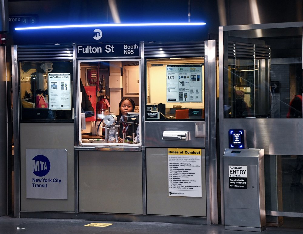 A subway station booth agent works at Fulton Center in Manhattan.